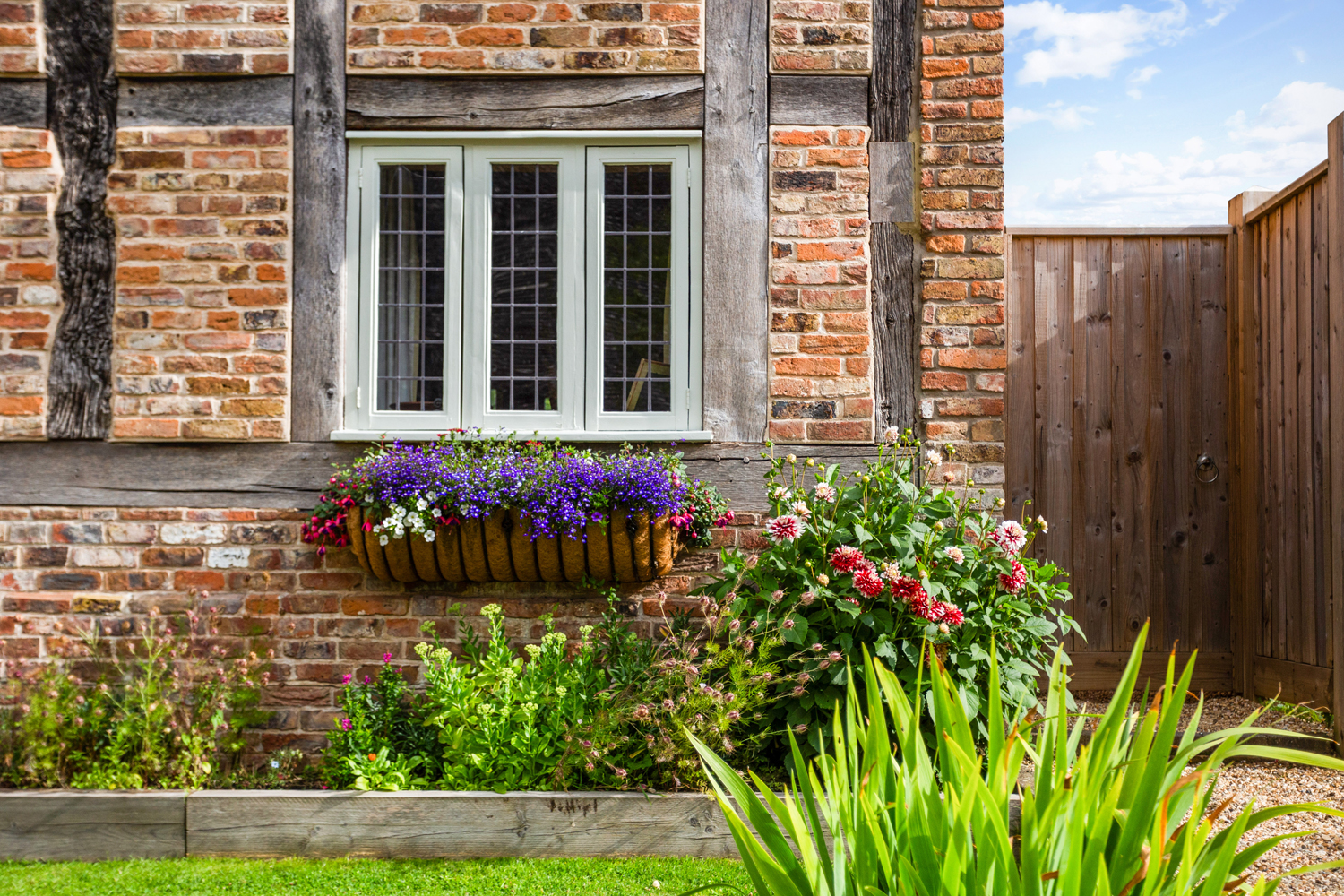 English country cottage window with flowers in basked